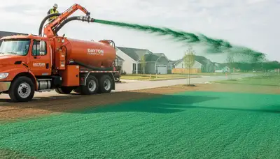 Hydroseeder truck spraying green slurry on new lawn in Dayton, OH by Chop Chop Landscaping